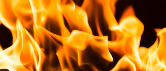 Fire flame burning glowing on black dark background, hot heat energy fuel fire motion pattern abstract texture.