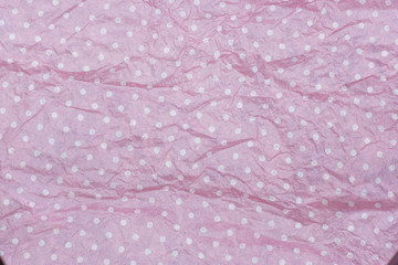 Pink color crumpled polka dot paper background