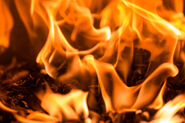 Fire flame burning glowing on black dark background, hot heat energy fuel fire motion pattern abstract texture.