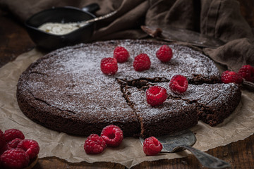 Chocolate mud cake swedish kladdkaka or sticky chocolate cake with raspberries on top