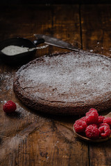Chocolate mud cake swedish kladdkaka or sticky chocolate cake with raspberries