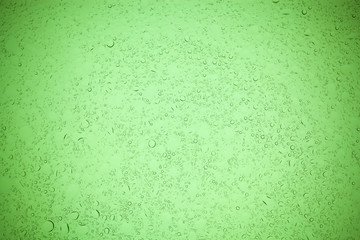 Rain droplets on green glass background, Water drops on green glass.