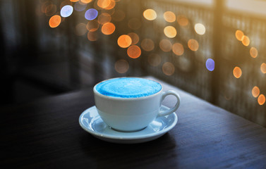 Cup of latte on wooden background.