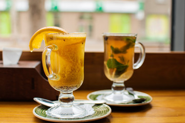 two warming traditional drinks grog and mulled wine with orange and cinnamon on a dark background...