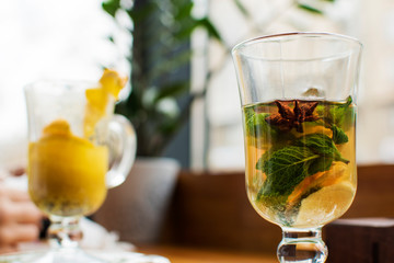 Half empty glass of black tea on the trasitional black and blue
