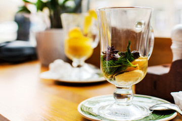 Half empty glass of black tea on the trasitional black and blue