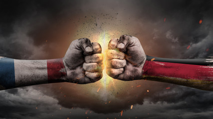 France vs Germany. Fists with flags. Battle of two countries on sky.	