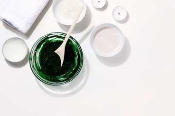 Spa,beauty cosmetics and body care treatment concept with copy space.Creative top view flat lay composition ingredients green spirulina cleansing mask bowl on white background.Horizontal orientation