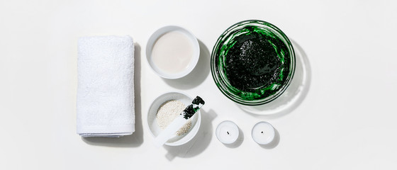 Spa,beauty cosmetics and body care treatment concept with copy space.Creative top view flat lay composition ingredients green spirulina cleansing mask bowl on white background.Horizontal orientation