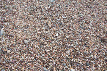 top view of a small stone surface on a sandy beach is the background for product design.