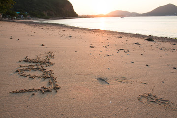 The empty beach floor has the word love.
