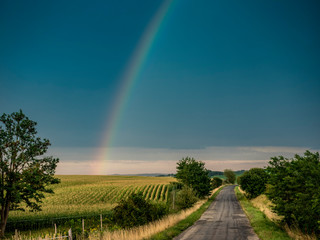Landscape in hungary with dramatic weather and rainbow.