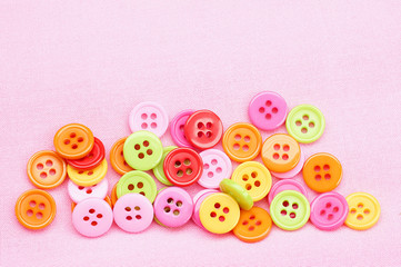 Fototapeta na wymiar colored bright plastic buttons with a hole