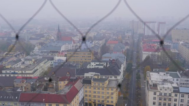 Pan looking out over the city of Ostrava to tourists observing from the view point on top of the New Town Hall in the Czech Republic