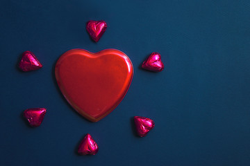 Romantic Valentine's day concept. Purple gift box shape heart on the dark blue backgrounds. Copy space, flat lay