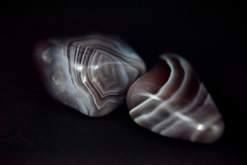 Polished agate on the dark background with the side light.