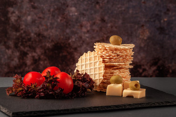 Crispy wafers made of wheat flour on a serving plate with lettuce