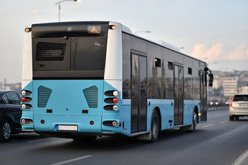 Low-floor city shuttle bus drive by city traffic