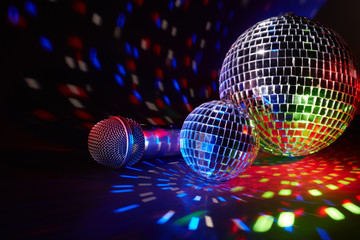 Microphone and  glittering mirror disco balls. Karaoke club. For advertising or web design. Entertainment or music show background