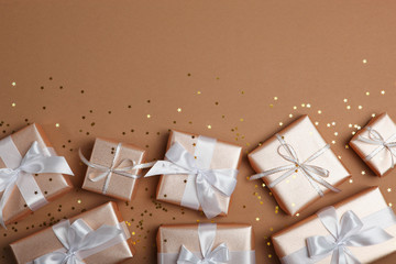 Gifts in gold packaging on a colored background with place for text top view. birthday, christmas, new year, mother's day, march 8, valentines day