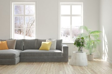 Stylish room in white color with sofa and winter landscape in window. Scandinavian interior design. 3D illustration