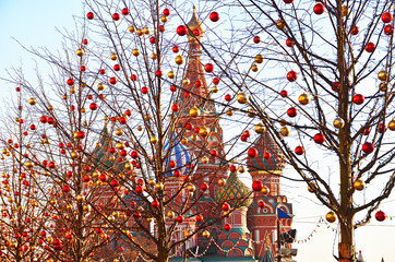 Trees decorated with Christmas balls in front of St. Basil's Cathedral in Moscow