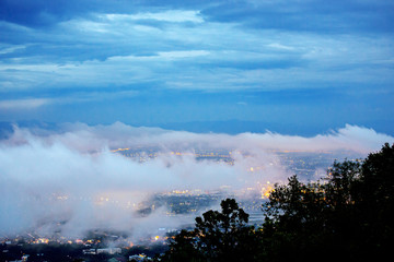 Scenery on top view of  Chiang Mai City on landscape Doi Suthep moutain in twilight sky with misty cloud