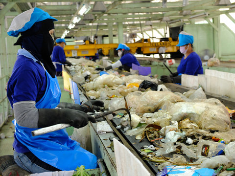 LAMPANGPROVINCE, THAILAND-DECEMBER 7 2016, Women in sepate line collect the plastic and metallic waste from household in waste disposal factory. Recyclable waste in dump site