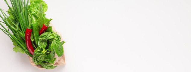 Green vegetables and red chili pepper in zero waste shopping bag