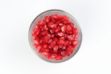 Red Pomegranate seed in glass on white background