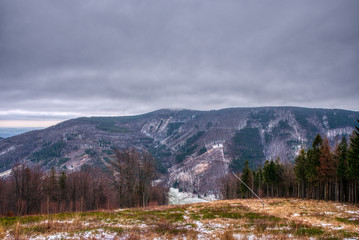 partly cover the mountains with snow in the mountains