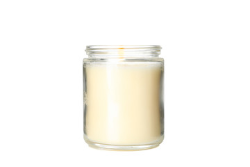 Yellow burning candle in glass jar isolated on white background