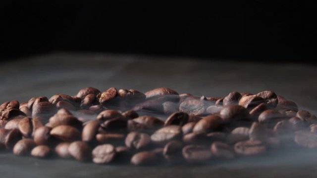 coffee beans spin on the board in smoke