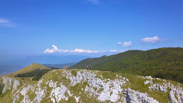Couple walking on edge of Nanos plateau, Slovenia, aerial shot