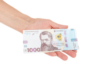 Thousand hryvnias by one banknote in the hand, isolated