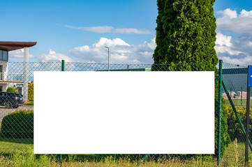 Blank white banner for advertisement on the fence of company headquarters