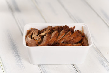 Fried Chinese duck, fast food in a plastic can