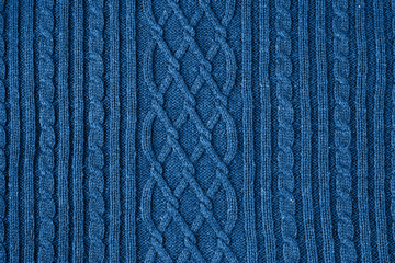 Knitted natural wool texture background in classic blue trendy color. Color of the year 2020.