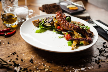 Fototapeta na wymiar Octopus salad served on a plate in restaurant