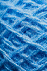 Wool yarn close-up colorful blue threads for needlework in macro.