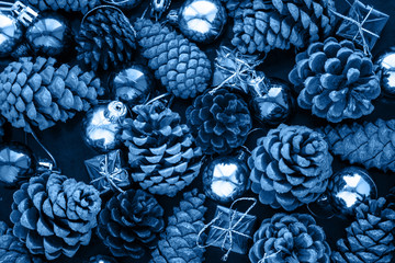 Christmas background with blue silver balls and pinecone in classic blue trendy color. Color of the...