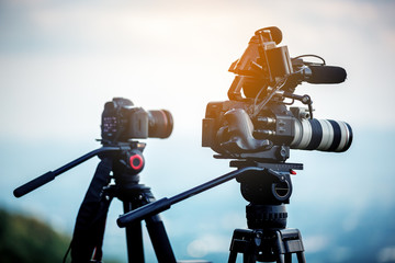 cinema camera on tripod in sunset , Video Production Concept