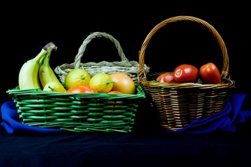 wicker basket with fruits in background with elegant cloth