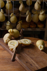 Sliced head of Italian hard cheese Scamorza or Caciocavallo with lime. caciocavallo - Italian cheese made from cow's or sheep's milk, closeup.