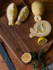 Sliced head of Italian hard cheese Scamorza or Caciocavallo with lime. caciocavallo - Italian cheese made from cow's or sheep's milk, closeup. Place for text on wooden rustic background top view.