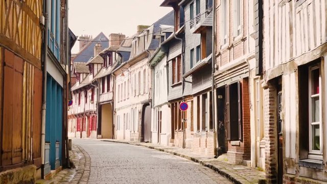 HONFLEUR, FRANCE - APRIL 08, 2018: view of empty beautiful street with old traditional houses at the center of Honfleur, Normandy, France