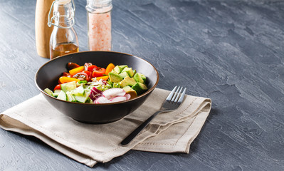 Vegan buddha bowl. Healthy vegetarian salad with cherry tomatoes, cucumber, radish,, avocado and lettuce.