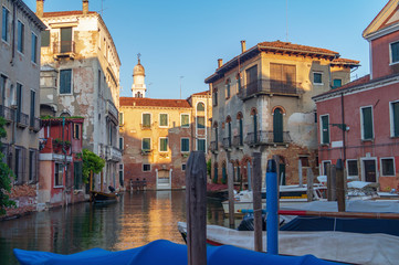 Fototapeta na wymiar Venice, Italy. Old traditional architecture houses and moored boats on the canal