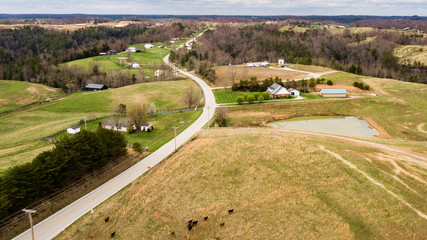 Overhead view of road traveling through the farmland and countryside © JCL Aerial Services