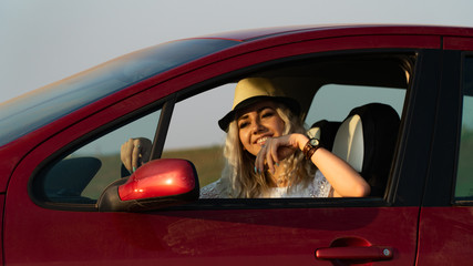 Beautiful sexy blonde woman, red car, field